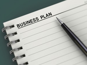 Notebook with business plan title and pen. Good for business concept